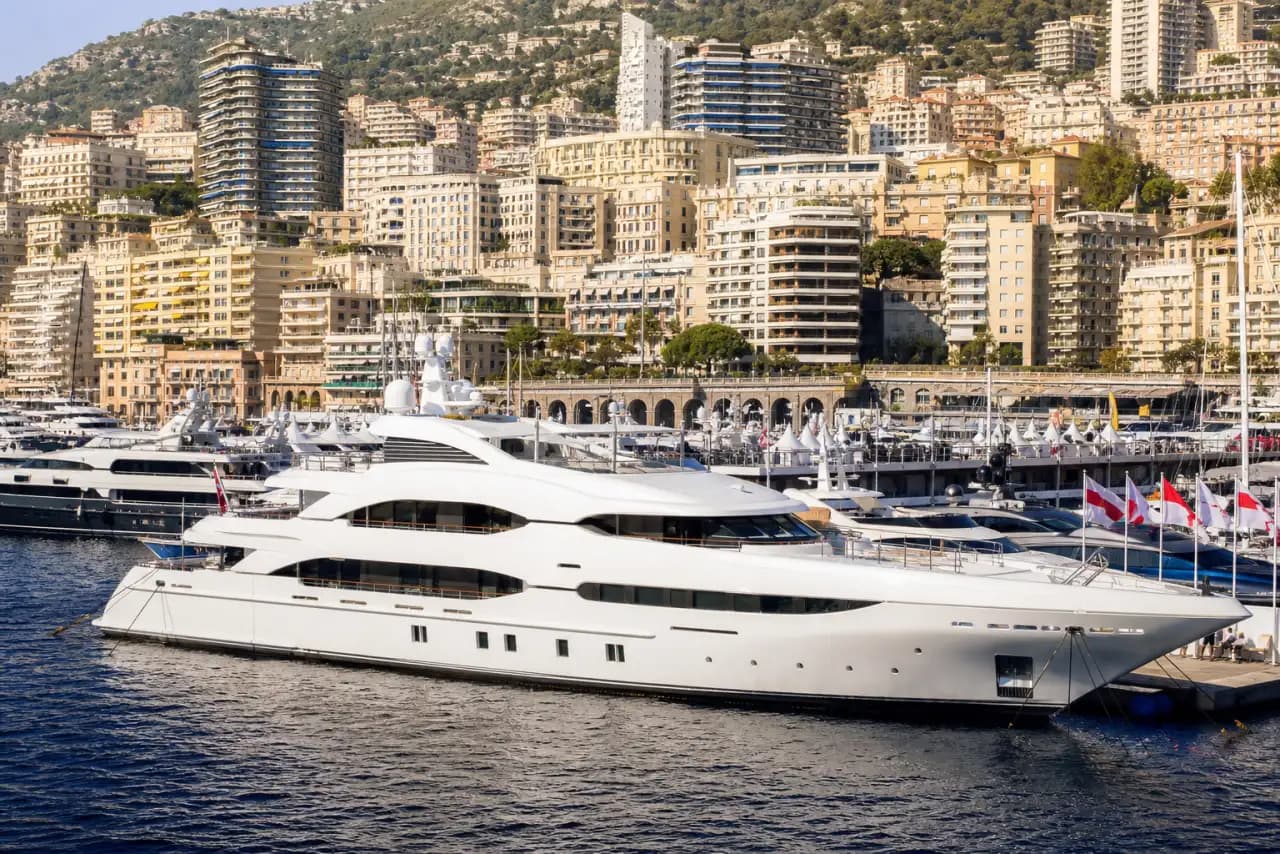 Mega yacht charter with large superyachts in a marina