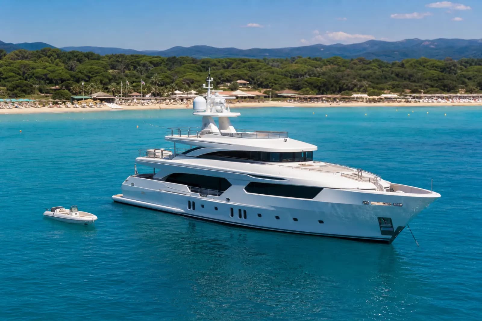 Spain luxury yacht charter with a superyacht near a Mediterranean beach
